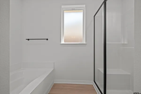 a bathroom with a granite countertop sink a toilet and shower