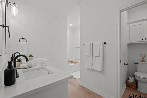 a view of an empty room with a window and a ceiling fan