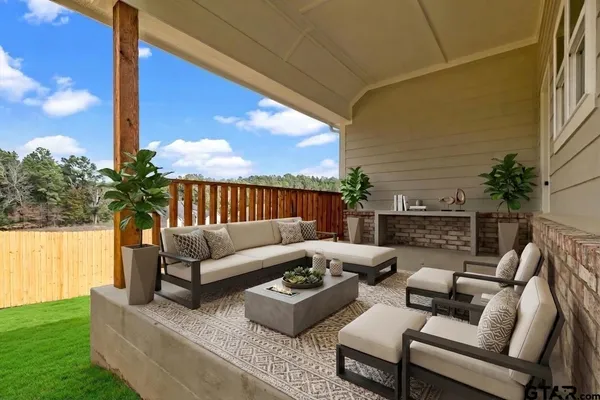 an empty room with a window and chandelier fan