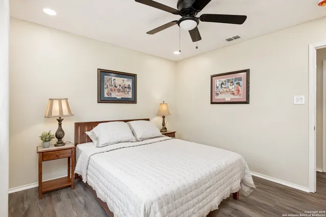 a bedroom with a large bed and a chandelier