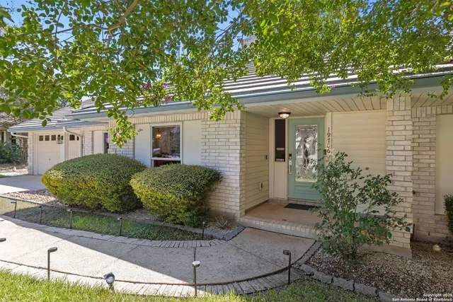 a view of a house with a small yard and plants