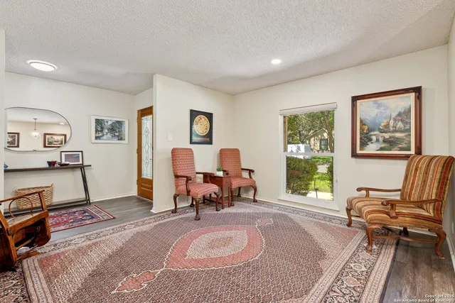 a living room with furniture a window and a flat screen tv