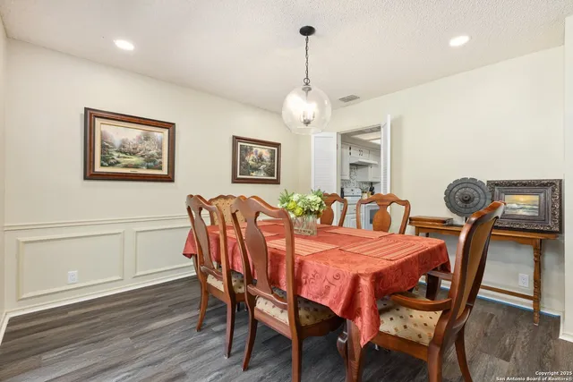 a view of a dining room with furniture wooden floor and chandelier
