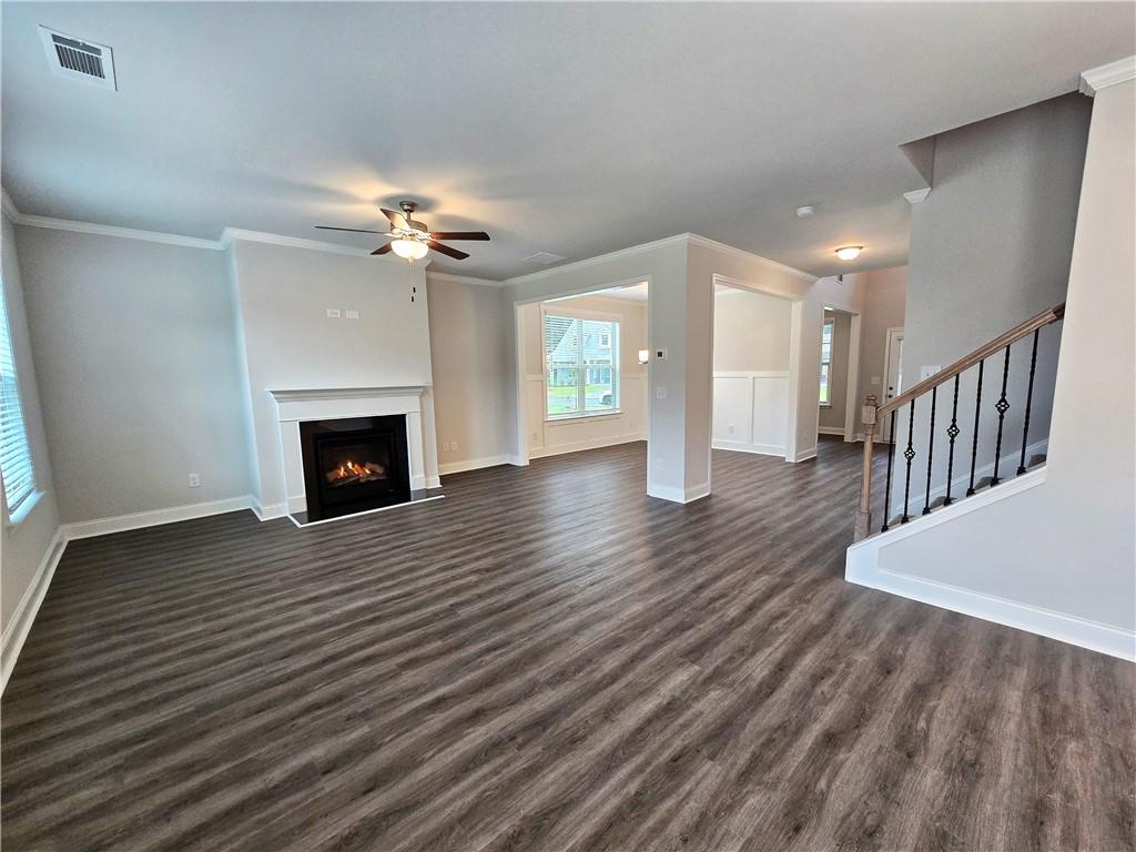 3856 Lockaby Way Lawrenceville, GA 30044 - Photo 11 of 36 a view of an empty room with wooden floor fireplace and a window