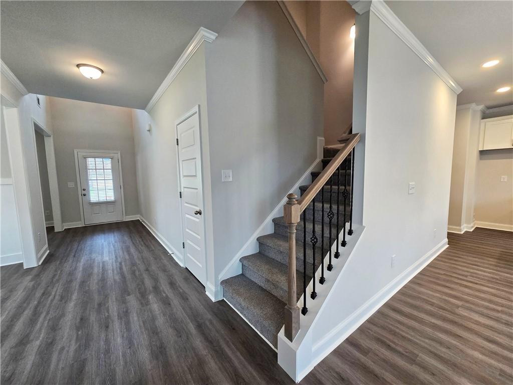 3856 Lockaby Way Lawrenceville, GA 30044 - Photo 13 of 36 a view of a hallway with wooden floor and stairs
