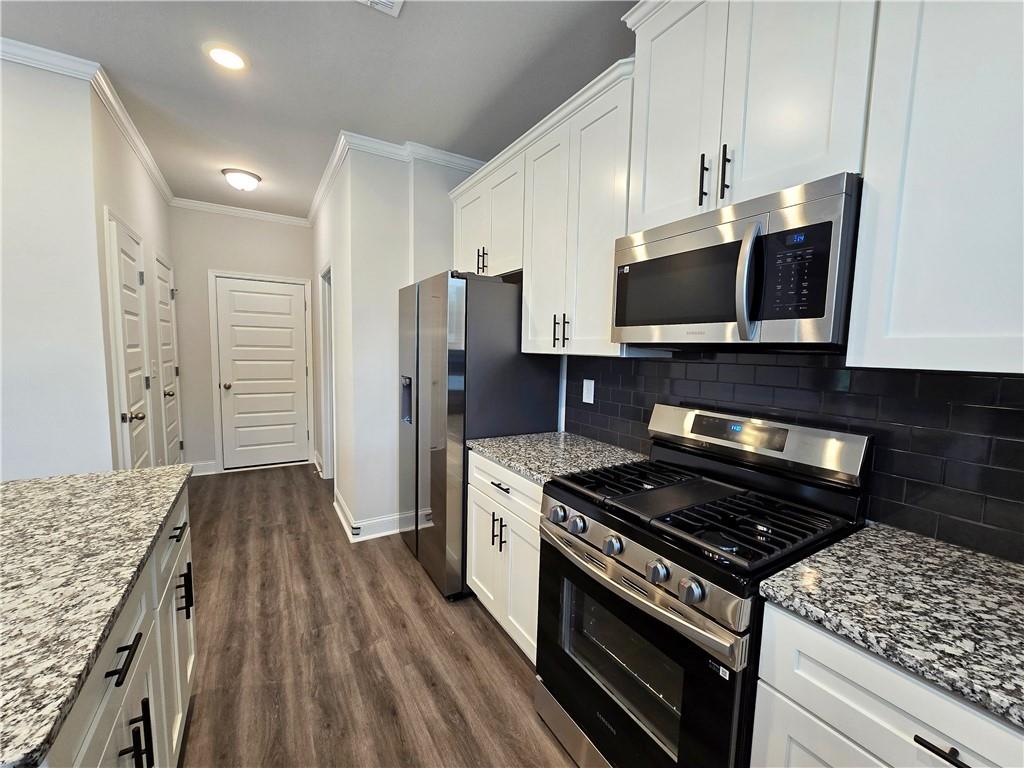 3856 Lockaby Way Lawrenceville, GA 30044 - Photo 20 of 36 a kitchen with refrigerator and microwave