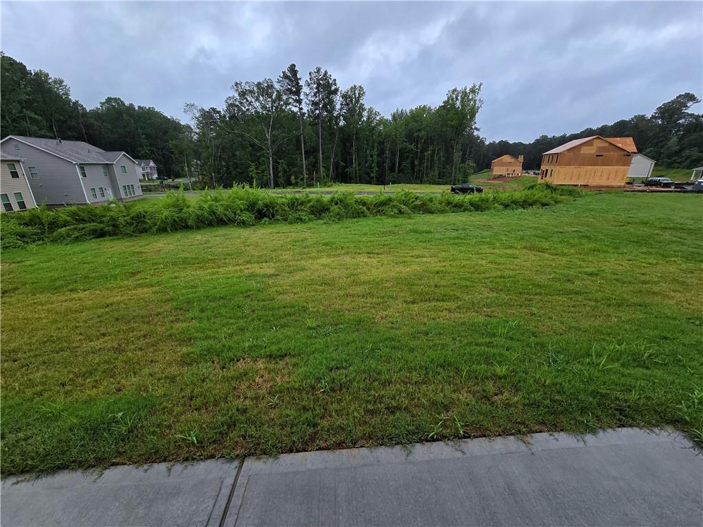 3856 Lockaby Way Lawrenceville, GA 30044 - Photo 24 of 36 a view of a garden with a building in the background