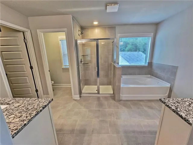 a bathroom with a shower and a toilet