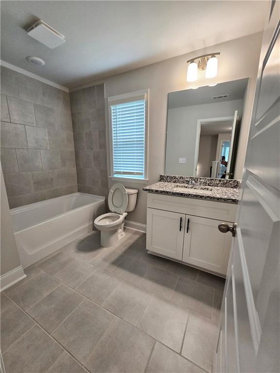 3856 Lockaby Way Lawrenceville, GA 30044 - Photo 36 of 36 a bathroom with a granite countertop sink a toilet and bathtub