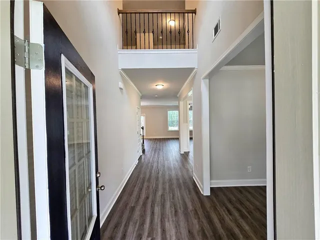 a view of hallway with wooden floor