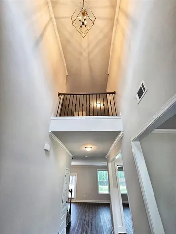 a view of entryway and hall with wooden floor