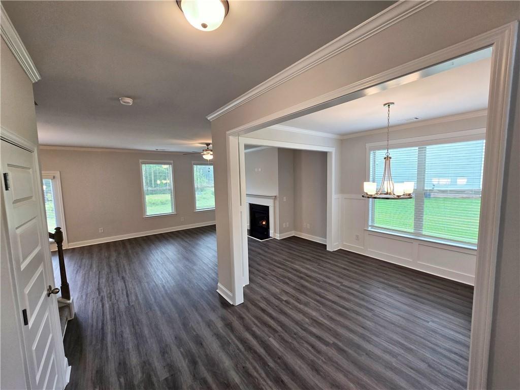 3856 Lockaby Way Lawrenceville, GA 30044 - Photo 8 of 36 an empty room with wooden floor and windows