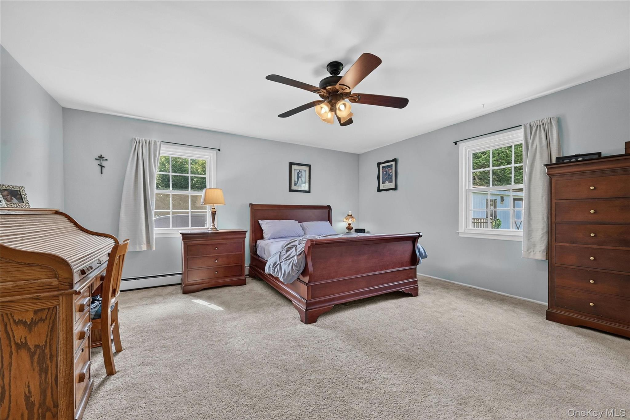 5 Hedges Road Warwick, NY 10990 - Photo 24 of 48 The spacious primary bedroom offers a calm, comfortable retreat with neutral finishes, soft natural light, and plenty of room for a full furniture arrangement.