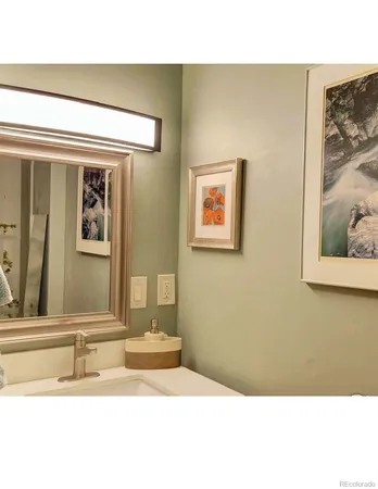 a bathroom with a sink a mirror and a shower