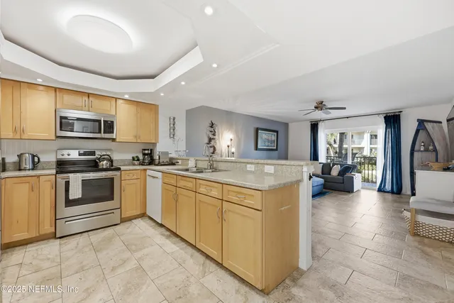 a kitchen with stainless steel appliances granite countertop a refrigerator and a sink