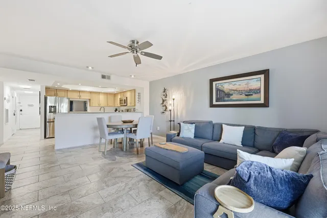 a bedroom with a bed and a large mirror on the dresser