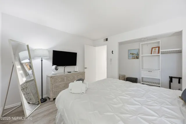 a bathroom with a sink a toilet a mirror a vanity and shower