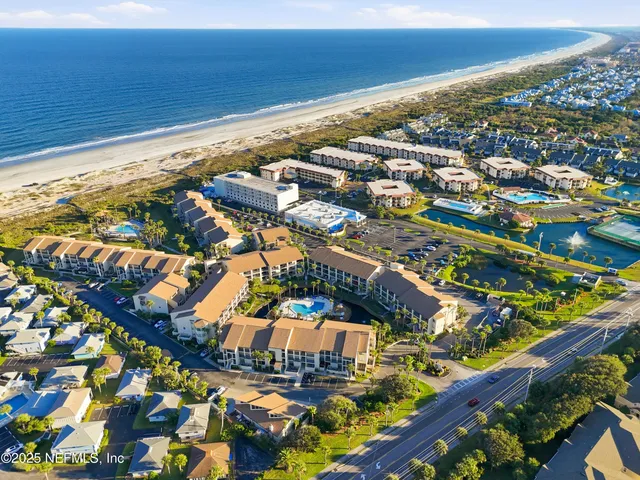 an aerial view of a house with a ocean view