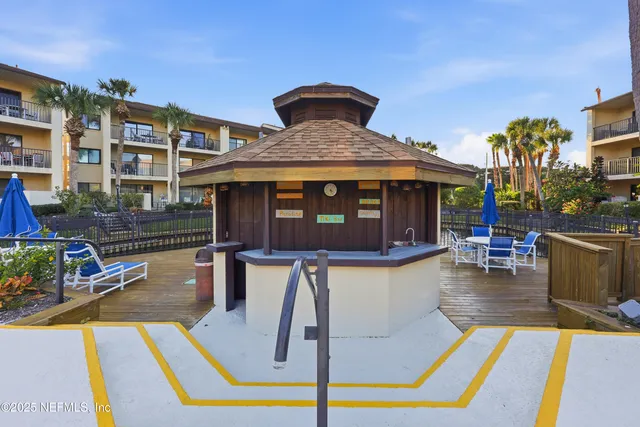 a view of a balcony with outdoor seating
