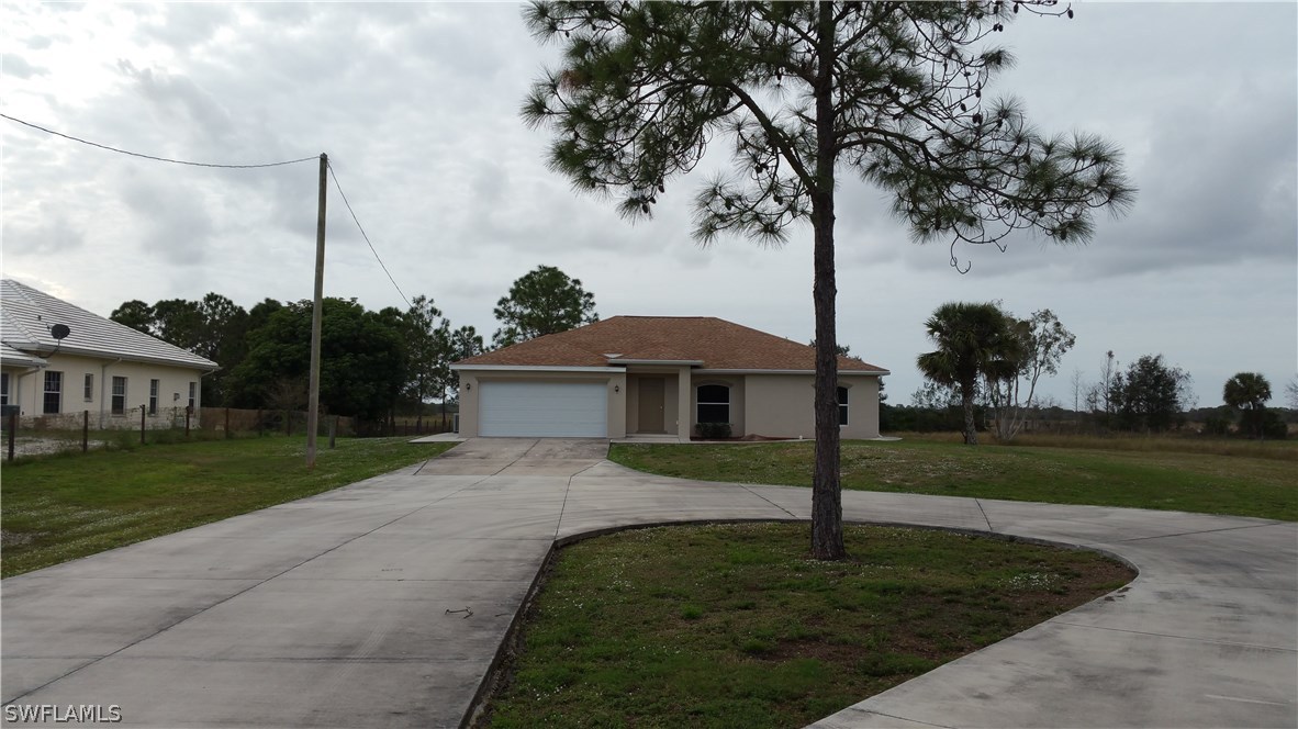 11890 Shawnee Road Fort Myers, FL 33913 - Photo 1 of 21 a front view of a house with garden