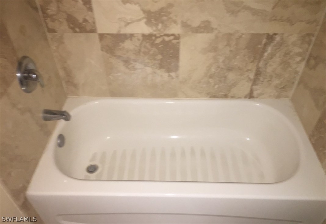 11890 Shawnee Road Fort Myers, FL 33913 - Photo 12 of 21 a bathroom with a bathtub