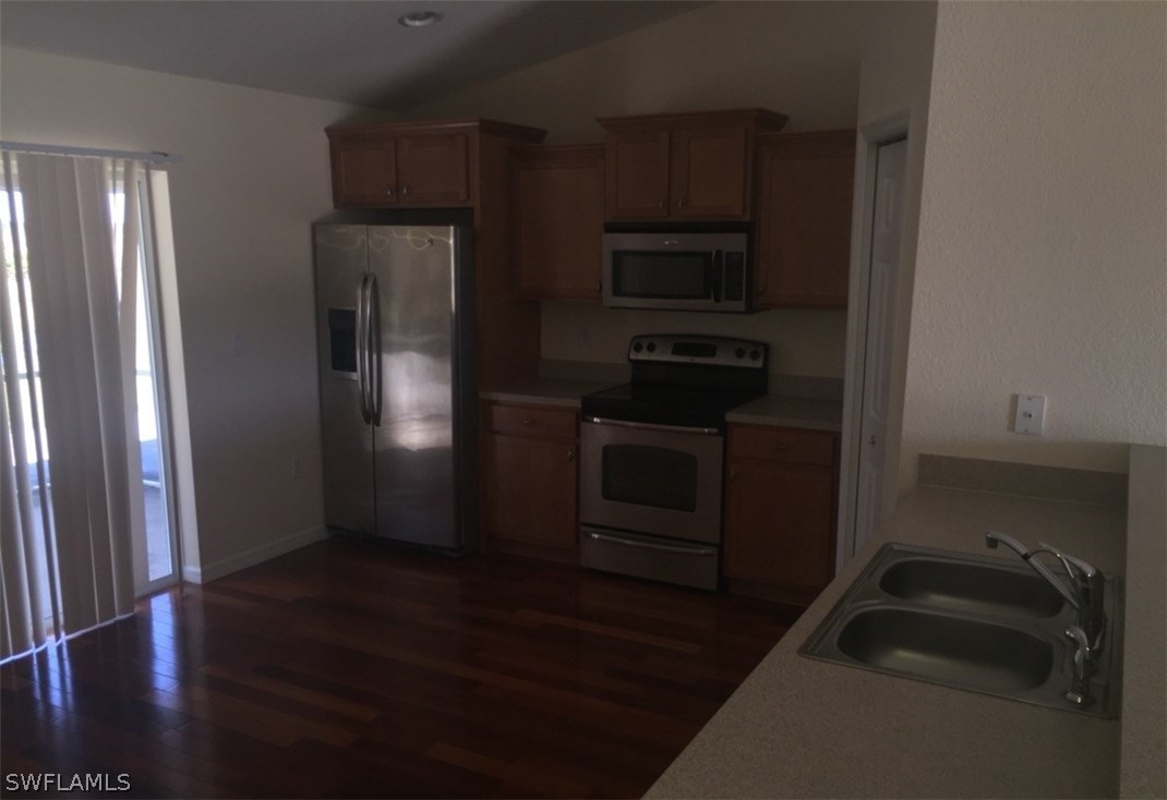 11890 Shawnee Road Fort Myers, FL 33913 - Photo 19 of 21 a kitchen with a refrigerator stove and cabinets