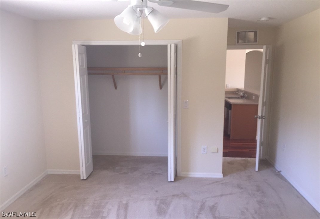 11890 Shawnee Road Fort Myers, FL 33913 - Photo 20 of 21 an empty room with closet and a chandelier fan