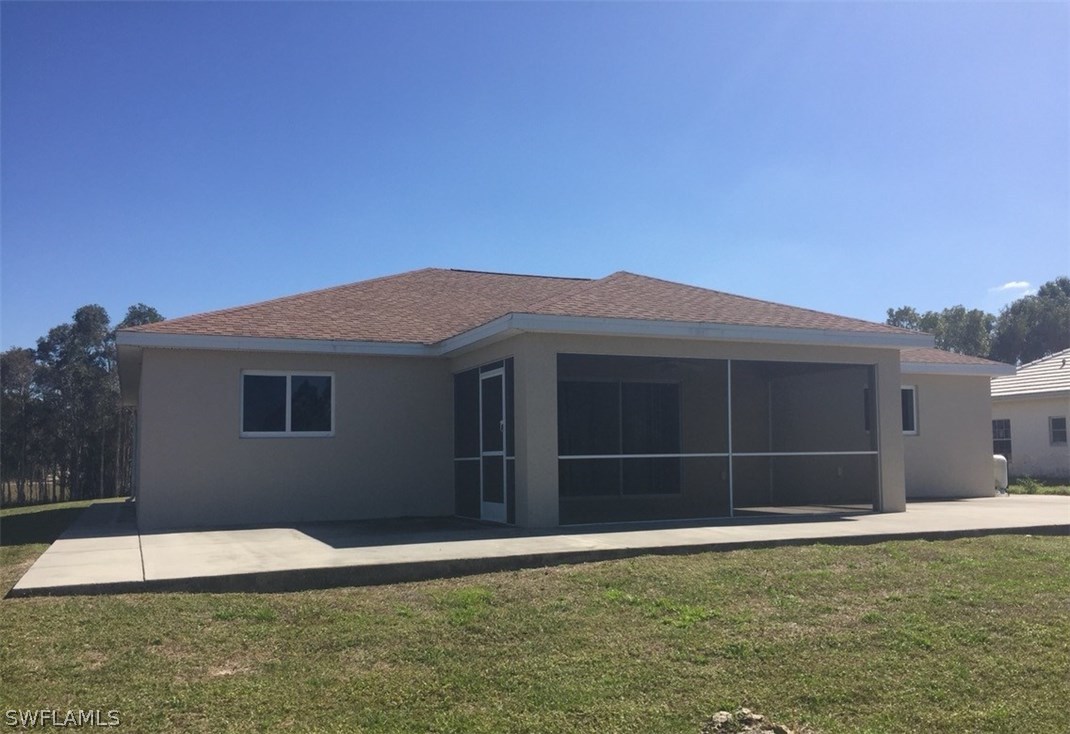 11890 Shawnee Road Fort Myers, FL 33913 - Photo 6 of 21 a house with a yard