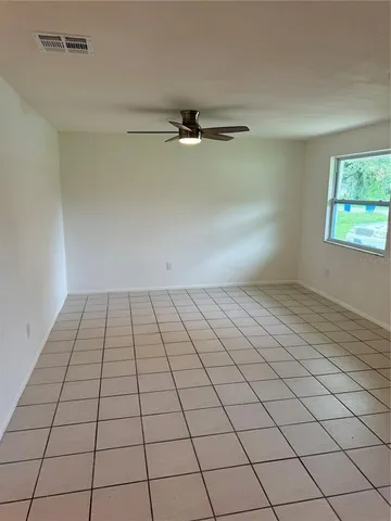 a kitchen with a refrigerator sink and cabinets