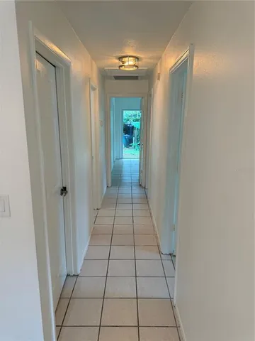 an empty room with a ceiling fan and window