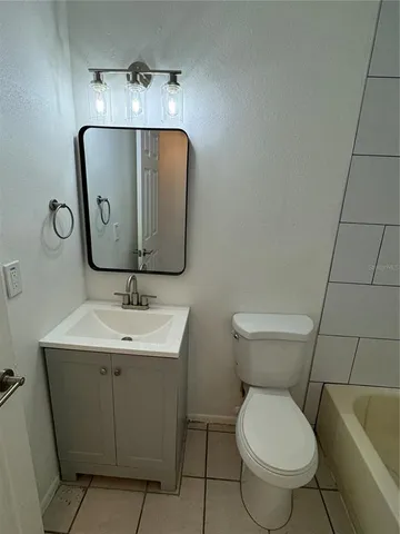 a bathroom with a bathtub and toilet