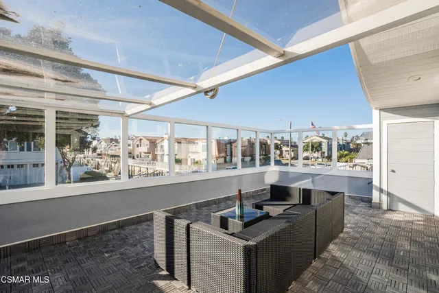 a room with stainless steel appliances kitchen island granite countertop a sink and cabinets