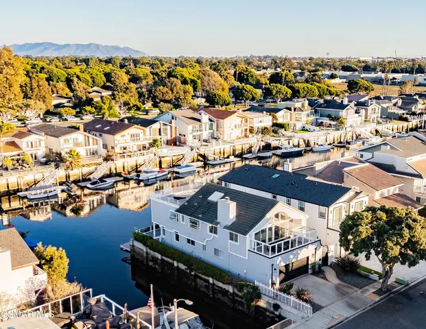 an aerial view of a house with a ocean view