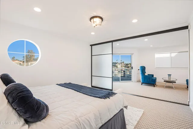 a bedroom with a bed and a painting on the wall