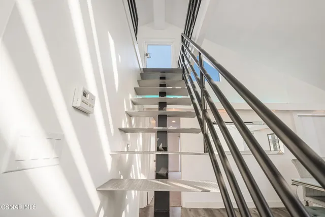 a view of a hallway with seating space