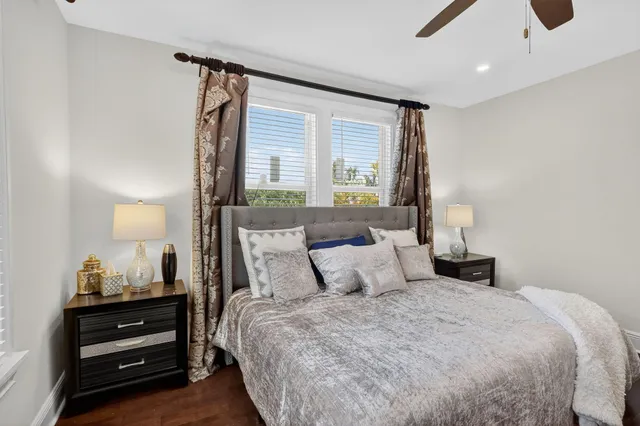 a bedroom with two beds and a large window