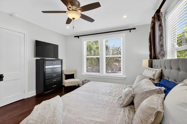 a bedroom with a bed and a chandelier