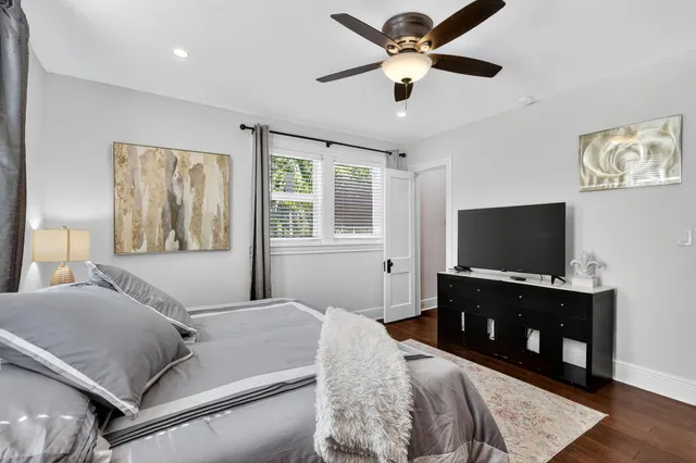 a bedroom with a bed and a flat screen television