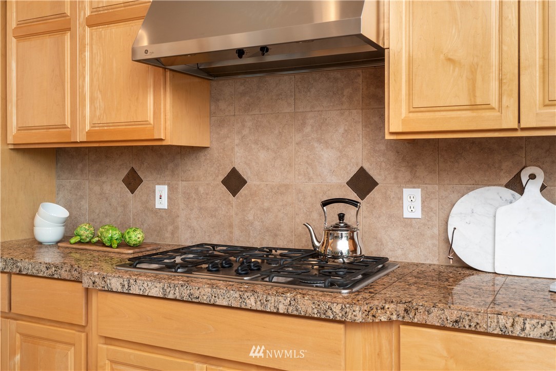 2512 204th Street Southeast Bothell, WA 98021 - Photo 14 of 37 a kitchen with granite countertop a sink stove and cabinets