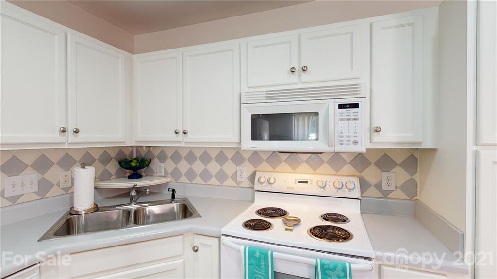 11642 Rabbit Ridge Road Charlotte, NC 28270 - Photo 11 of 45 a kitchen with a sink a stove and cabinets