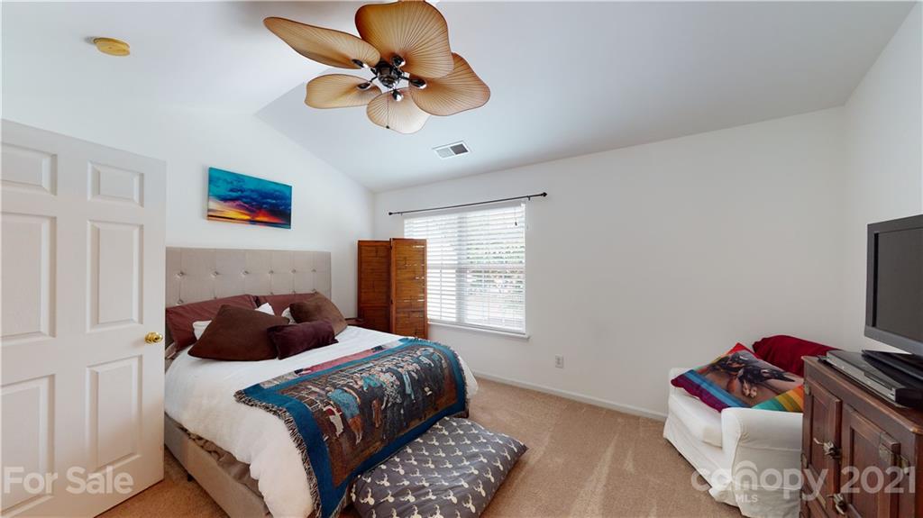 11642 Rabbit Ridge Road Charlotte, NC 28270 - Photo 20 of 45 a bedroom with a bed and a chandelier