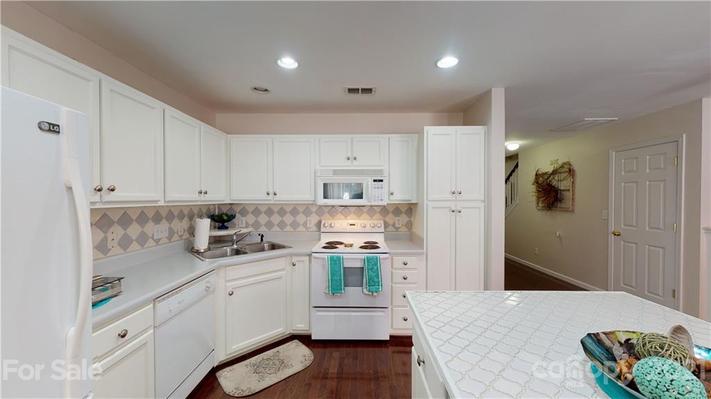 11642 Rabbit Ridge Road Charlotte, NC 28270 - Photo 2 of 45 a kitchen with a stove a refrigerator sink and cabinets