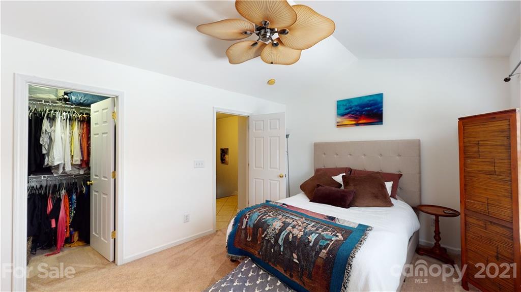 11642 Rabbit Ridge Road Charlotte, NC 28270 - Photo 21 of 45 a bedroom with a bed and a chandelier