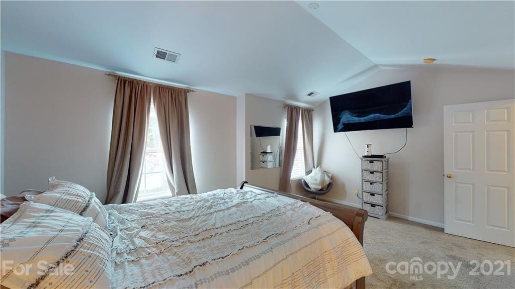 11642 Rabbit Ridge Road Charlotte, NC 28270 - Photo 22 of 45 a bedroom with a bed and a flat screen tv