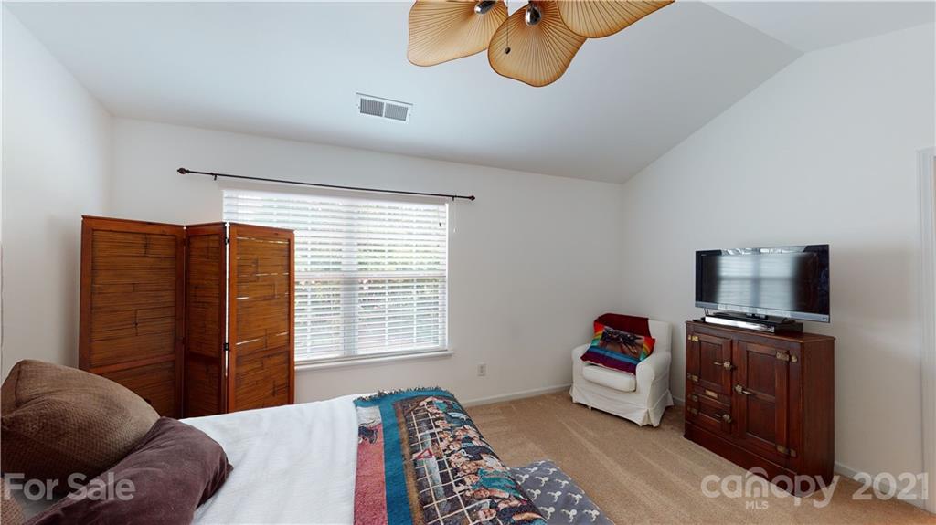 11642 Rabbit Ridge Road Charlotte, NC 28270 - Photo 26 of 45 a bedroom with a bed and a television