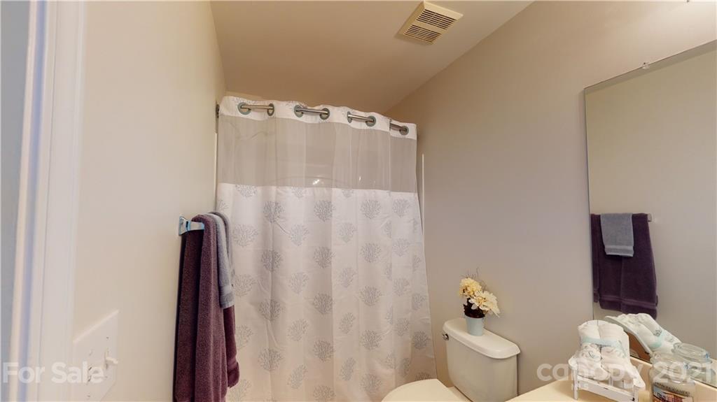 11642 Rabbit Ridge Road Charlotte, NC 28270 - Photo 27 of 45 a bathroom with a bathtub and shower curtain