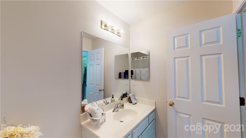 11642 Rabbit Ridge Road Charlotte, NC 28270 - Photo 30 of 45 a bathroom with a sink vanity and mirror