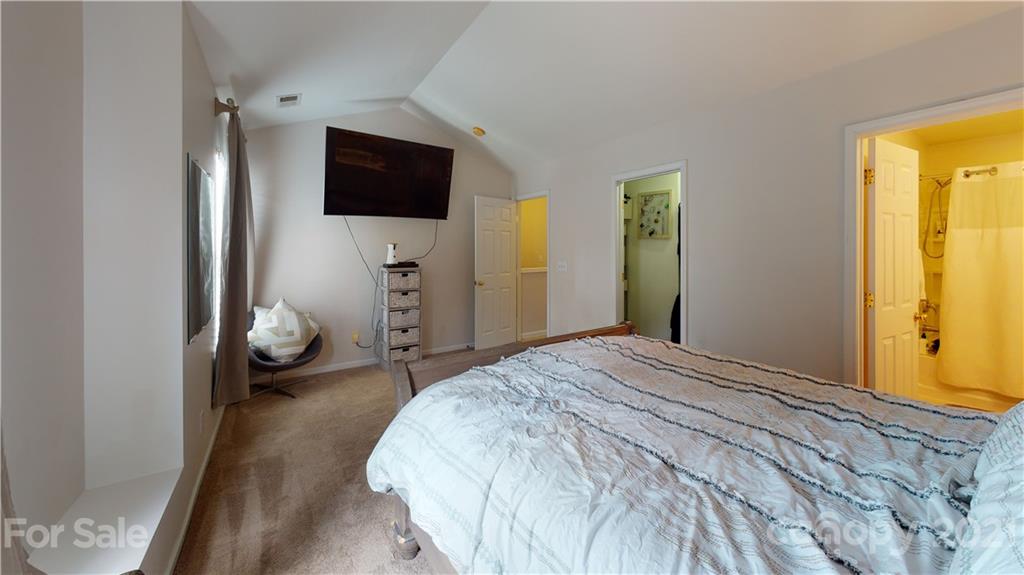 11642 Rabbit Ridge Road Charlotte, NC 28270 - Photo 31 of 45 a bedroom with a bed and flat tv screen