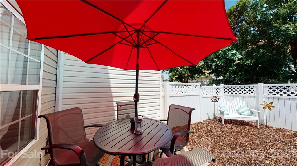 11642 Rabbit Ridge Road Charlotte, NC 28270 - Photo 39 of 45 a view of a patio with a table and chairs under an umbrella