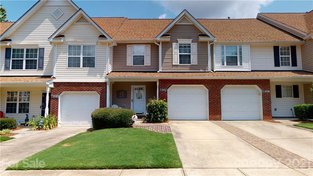 11642 Rabbit Ridge Road Charlotte, NC 28270 - Photo 4 of 45 a front view of a house with a yard and garage